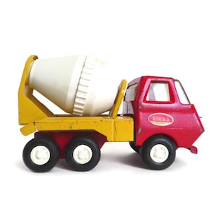 May include: A red and yellow Tonka toy cement mixer truck with a white rotating drum. The truck has four black wheels and a Tonka logo on the side.