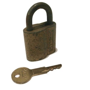 May include: A brass padlock with a key. The padlock has a tarnished finish and the key has a brass finish.
