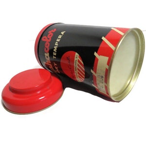 May include: A red and black paint can with the text "Ja-color Dry Tempera" and "Made in U.S.A." The can has a red lid.