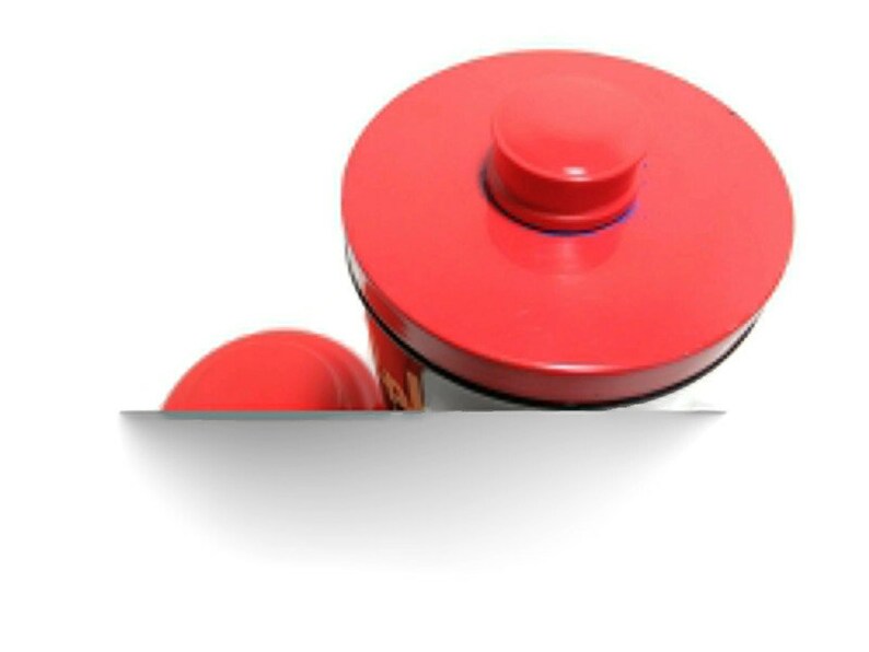 May include: Red metal container with a red lid and a black base. The lid has a small red knob on top.