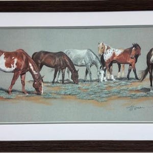 May include: A framed print featuring a herd of horses grazing in a field. The horses are various colors, including brown, white, and gray. The artwork is set against a muted background, with a brown frame.