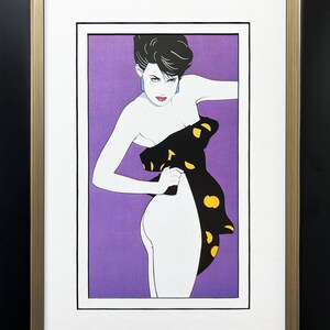 May include: A framed print of a woman in a black and yellow polka dot dress. The woman is standing with her back to the viewer, and she is looking over her shoulder. The background is a solid purple color.