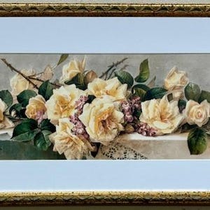 May include: A framed watercolor painting of a bouquet of white roses with green leaves and purple flowers. The roses are arranged on a white surface with a lace doily.