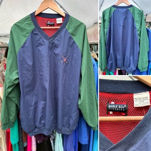 May include: A blue and green windbreaker jacket with a red mesh lining. The jacket has a v-neck and a Bugle Boy Classics logo on the front. The jacket is made of 100% polyester.