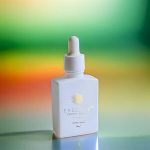 May include: A white, square bottle with a dropper top. The bottle has gold text that reads "ESSENCE" and "EMBODY DIVINE". The bottom of the bottle reads "SIDERIC DROPS" and "50ml".