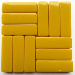 May include: A set of nine yellow glass tiles arranged in a grid pattern. The tiles are rectangular and have a smooth, glossy finish.