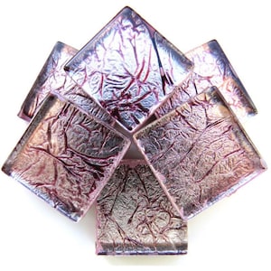 May include: Six square-shaped glass tiles with a metallic silver and pink iridescent finish. The tiles have a textured surface that resembles crumpled foil.