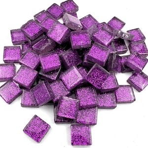 May include: A pile of small, square, purple mosaic tiles with glitter embedded within. The tiles are scattered, showing their reflective, glossy surfaces. The color is a vibrant, deep purple, and the glitter adds a sparkling effect. These tiles are suitable for craft projects.