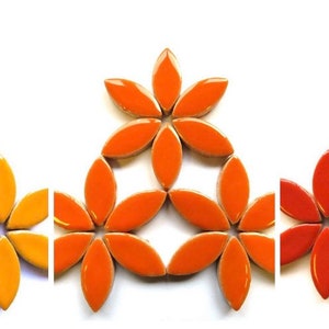 May include: Three sets of ceramic flower-shaped tiles in yellow, orange and red. Each set is arranged in a triangular pattern.
