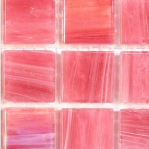 May include: A sheet of pink glass mosaic tiles with a subtle striated pattern. Each tile is square and measures approximately 1 inch by 1 inch.