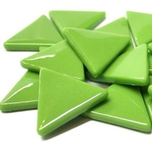 May include: A pile of green glass triangle mosaic tiles. The tiles are glossy and have a smooth surface.