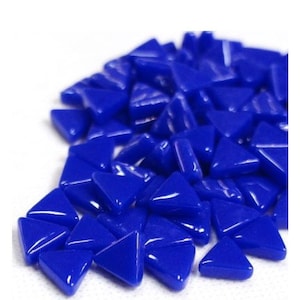 May include: A pile of glossy, triangular mosaic tiles in a vibrant shade of blue. The tiles are smooth and uniform in shape, with a slight sheen. These decorative tiles are ideal for various craft projects.