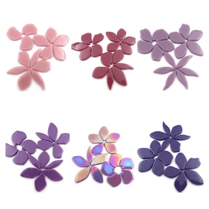 May include: Assortment of glass flower shapes in various shades of pink, purple, and lavender. The flower shapes are perfect for crafting and creating mosaic art.