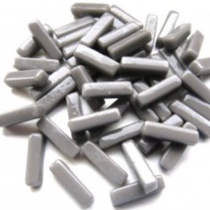 May include: A pile of gray glass tiles in a rectangular shape. The tiles are smooth and glossy.