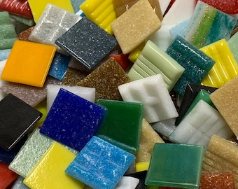 May include: A variety of small, square mosaic tiles in various colors, including blue, green, yellow, red, and white. The tiles are made of glass and have a textured surface.