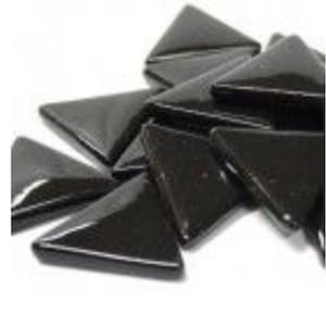 May include: A pile of black triangular glass mosaic tiles. The tiles are shiny and have a slightly textured surface.
