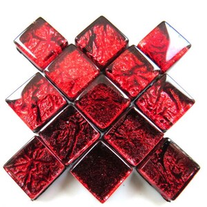 May include: A set of 12 red glass mosaic tiles with a textured, metallic finish. The tiles are arranged in a diamond pattern.
