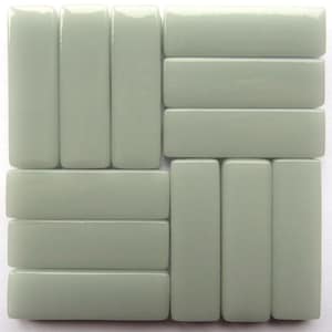 May include: A set of nine rectangular ceramic tiles in a light sage green color. The tiles are arranged in a staggered pattern.
