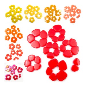 May include: Assortment of colorful glass flower shapes in red, orange, yellow, and pink. The flower shapes are made of glass and have a smooth, glossy finish.