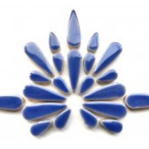 May include: A collection of blue ceramic tile pieces in the shape of teardrops. The tiles are arranged in a symmetrical pattern, creating a starburst design.