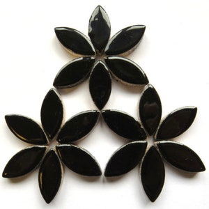 May include: Black ceramic flower-shaped tiles arranged in a triangular pattern. The tiles are glossy and have a smooth surface.