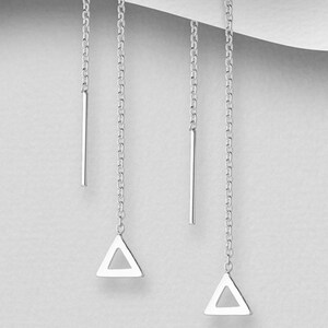 May include: A pair of silver dangle earrings with a triangle shape at the bottom of each chain.
