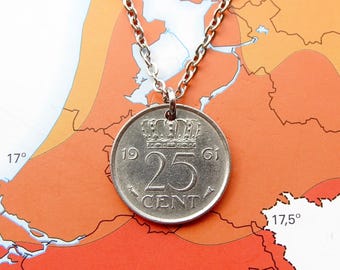 May include: A silver-toned coin pendant on a metal chain. The coin features a crown emblem above the number 25 and the word CENT, with the year 1961 split on either side. The design includes small decorative symbols flanking the text.