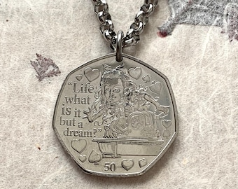 May include: A silver-coloured heptagonal coin pendant on a matching metal chain. The coin features an engraved illustration of a character, the text "Life, what is it but a dream?", the number 50, and various heart and spade symbols embossed on the surface.