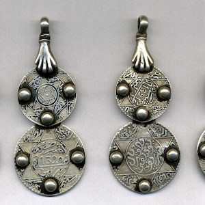Morocco – 4 Old Silver Pendants with ancient coins held by a hand of fatima