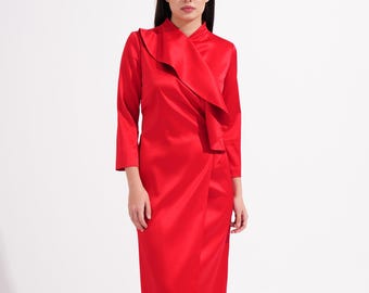 May include: A vibrant red midi dress featuring a high neckline, three-quarter length sleeves, and a prominent cascading ruffle detail that runs diagonally across the bodice. The garment has a straight skirt silhouette and a smooth, satin-like finish.