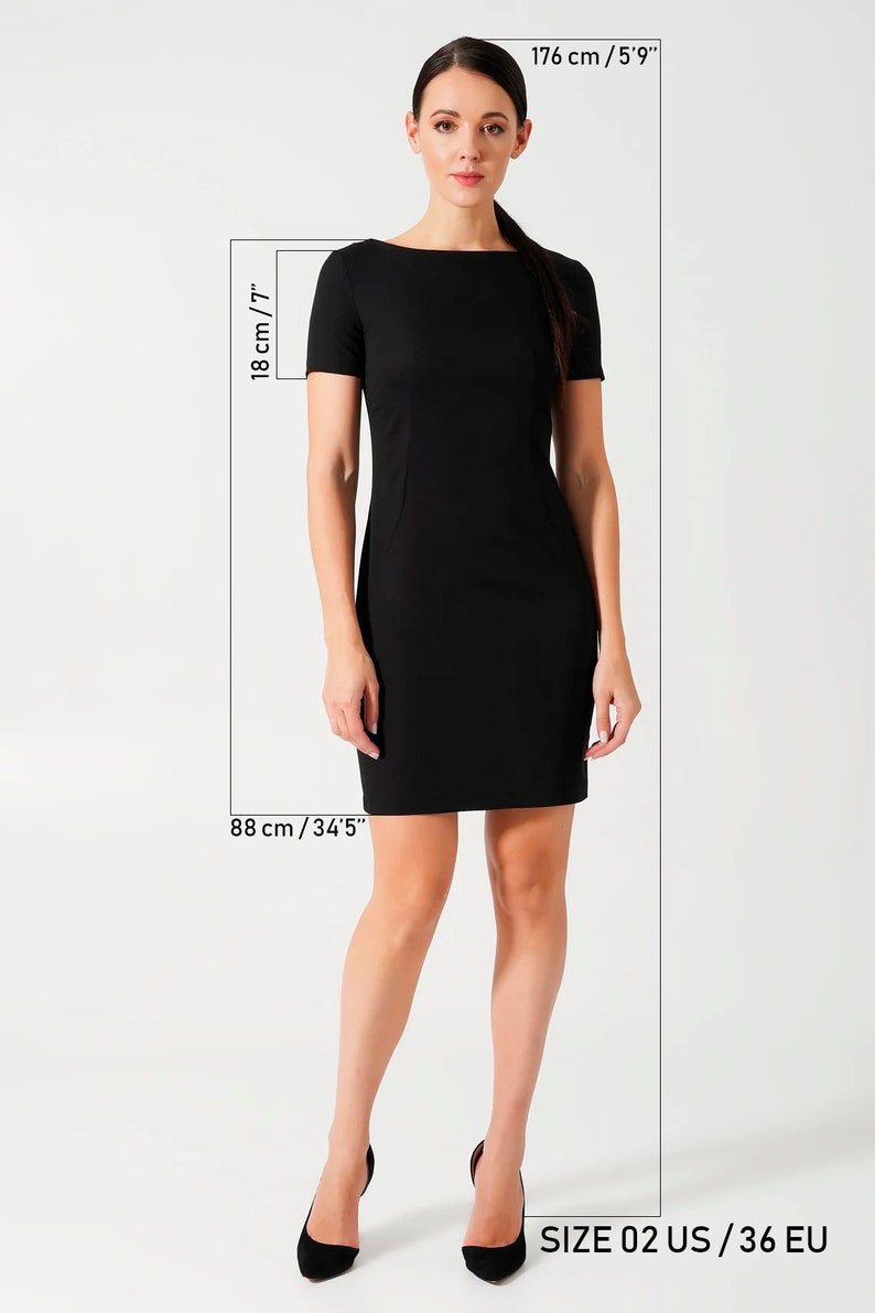 May include: A solid black short-sleeved dress with a boat neckline and a fitted silhouette. The dress is shown with measurement indicators including 18 inches for the sleeve length, 88 cm for the length, and a total height of 5'9 inches.