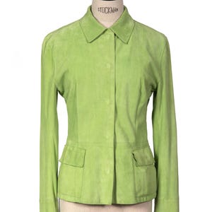 Peut inclure: Une veste en daim vert citron dotée d'un col classique, de manches longues et d'une fermeture à boutons sur le devant. Le vêtement comprend deux poches à rabat rectangulaires situées à la taille, offrant une apparence structurée.
