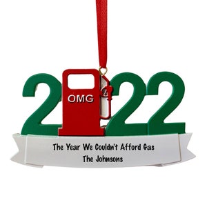 May include: Green 2022 Christmas ornament with a red gas pump that says "OMG" and a white banner that says "The Year We Couldn't Afford Gas The Johnsons"