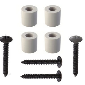 May include: Four white plastic furniture feet and two black screws with Phillips head. The screws are approximately 2 inches long.