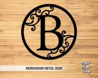 May include: Black metal monogram sign with a decorative scroll design and the letter B in the center. The sign is on a wood background.  MONOGROM METAL SIGN.