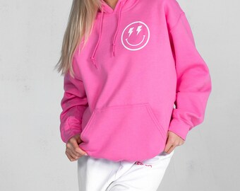 white hoodie with pink smiley face