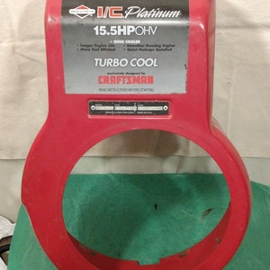 May include: Red engine cover for a Craftsman 15.5 HP OHV engine. The cover has a label that says "IC Platinum" and "Turbo Cool".
