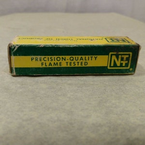May include: A green and yellow box with the text "National Torch Tip Product" and "Precision-Quality Flame Tested" on the front. The box has a logo with the letters "NT" in a yellow circle with a cross inside.