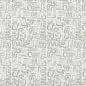 May include: White fabric with a repeating pattern of gray, abstract shapes. The text "Angela Harris - Minos Stormy Luxe Canvas" is printed at the bottom of the image.