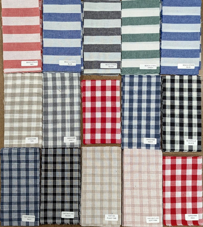 May include: A collection of 15 fabric swatches in various patterns and colors, including red, blue, black, green, tan, and white. The swatches are arranged in three rows of five. The fabric patterns include stripes, gingham, and plaid.