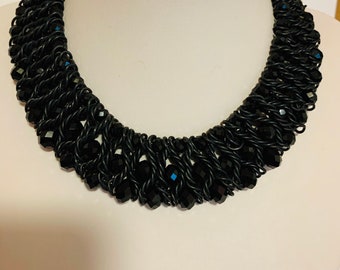 Short black beads and braided wire necklace.
