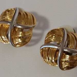 Gold tone textured metal with silver tone cross on front center clip on earrings