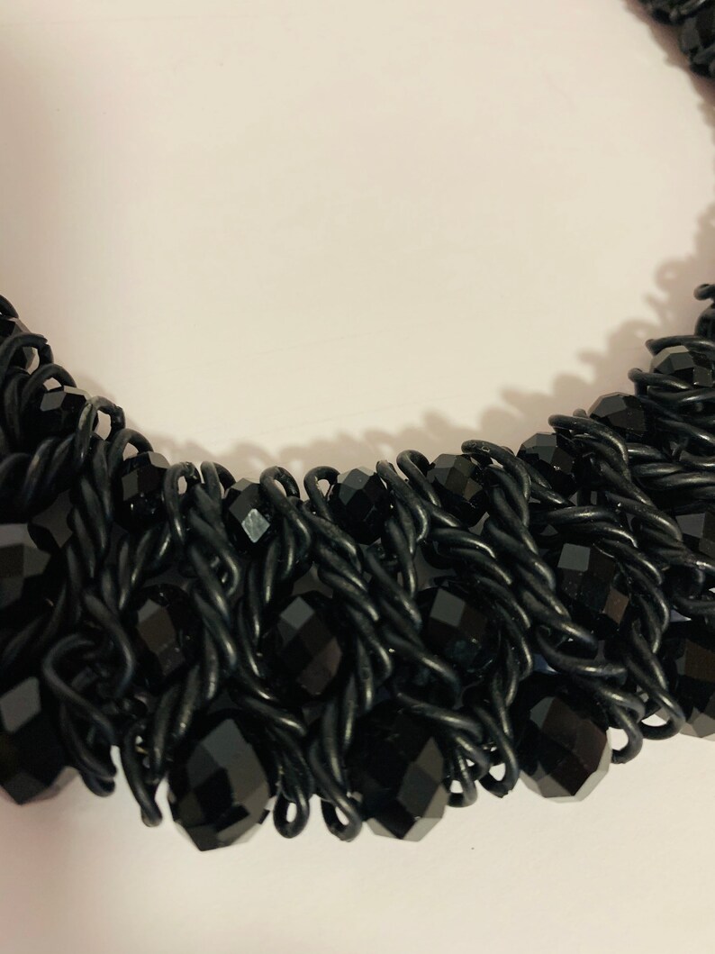 Short black beads and braided wire necklace.