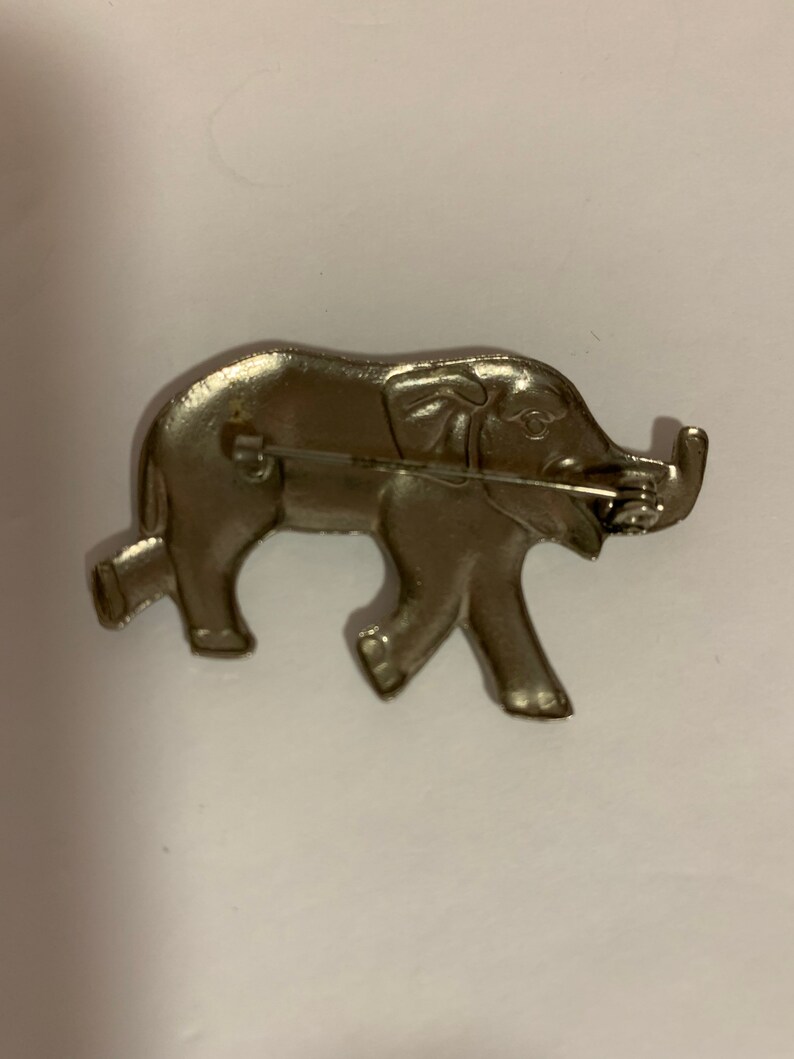 . good luck Silver tone metal elephant brooch with trunk up