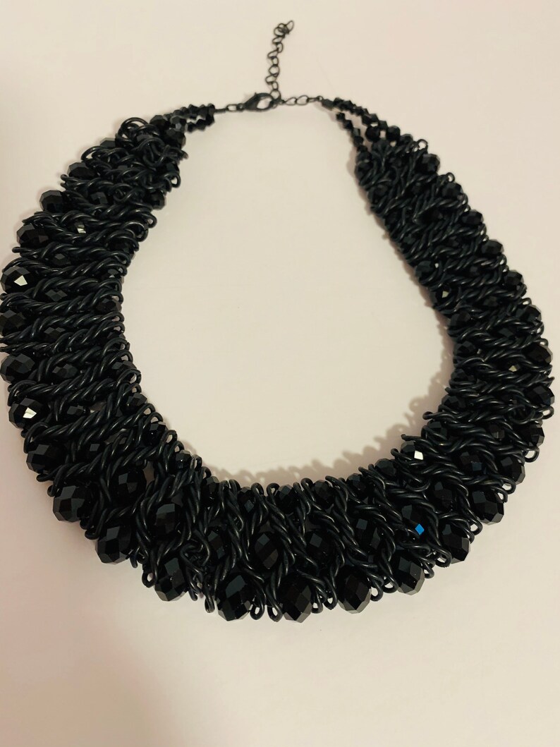 Short black beads and braided wire necklace.