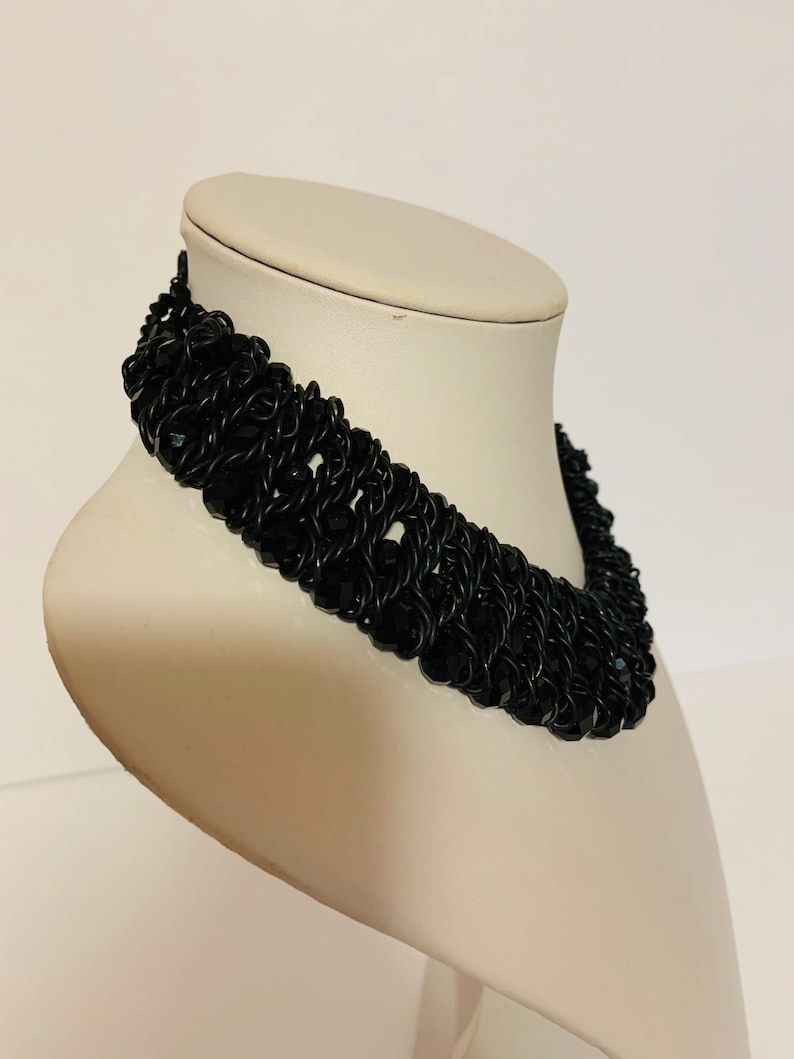 Short black beads and braided wire necklace.