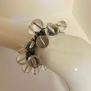 Clear beaded stretch bracelet with silver tone metal spacers.