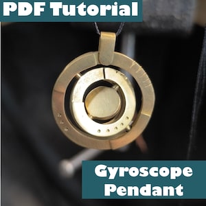 May include: A gold-toned metal gyroscope pendant suspended on a thin black cord. The circular pendant features concentric rings and a central disc. Text overlays read "PDF Tutorial" at the top and "Gyroscope Pendant" at the bottom of the image.