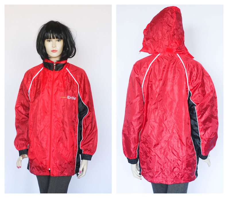 May include: Red hooded jacket with black and white trim and the word "Erbu" on the front.