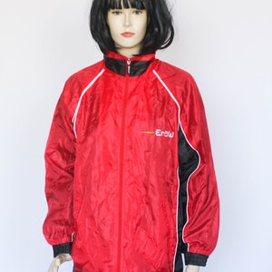 May include: Red, black, and white windbreaker jacket with white piping and a black zipper. The jacket has the word "Erbu" printed on the front in white.